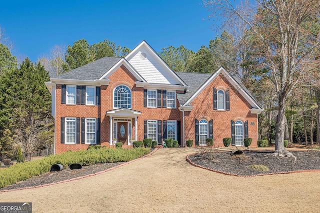 view of front facade with brick siding and driveway