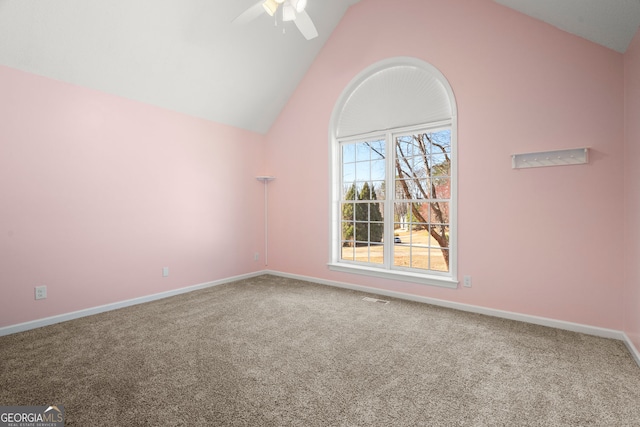 carpeted empty room featuring visible vents, baseboards, a ceiling fan, and vaulted ceiling