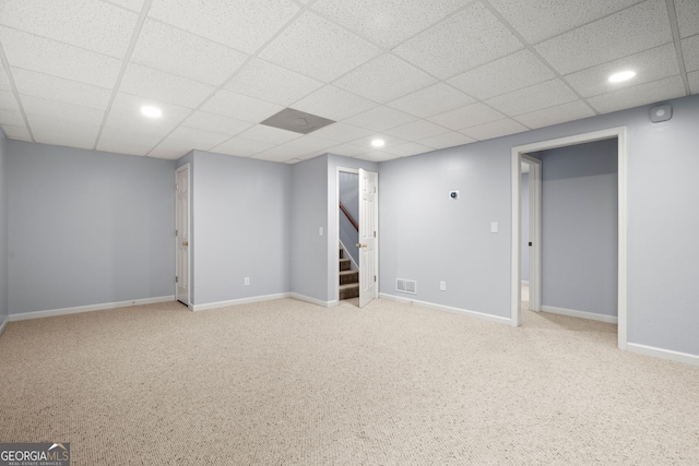 finished below grade area with stairway, carpet flooring, visible vents, and baseboards