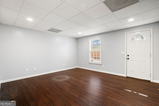 interior space featuring recessed lighting, baseboards, dark wood-style flooring, and a drop ceiling