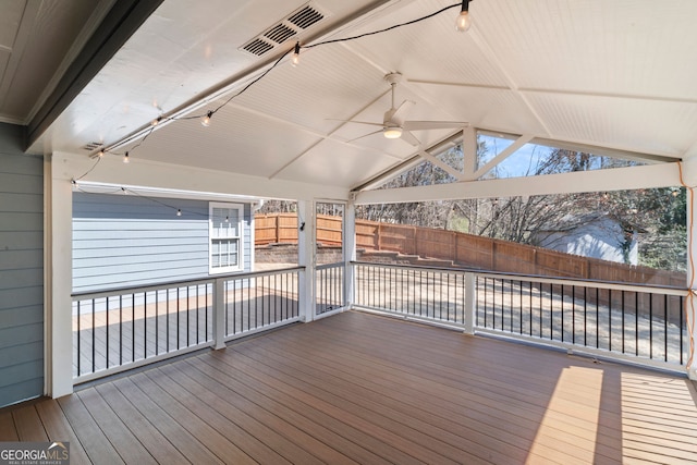 deck with ceiling fan, visible vents, a fenced backyard, and a patio area