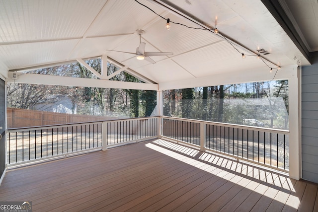 wooden deck featuring visible vents, a ceiling fan, and fence