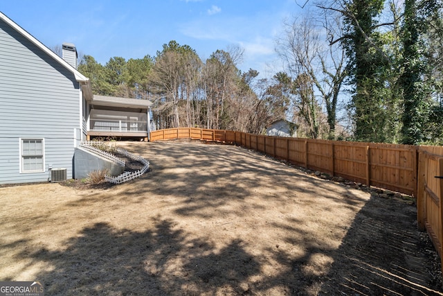 view of yard featuring central air condition unit and a fenced backyard