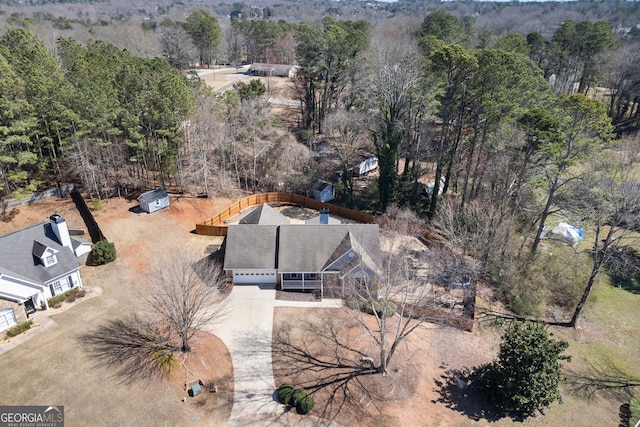 birds eye view of property featuring a wooded view