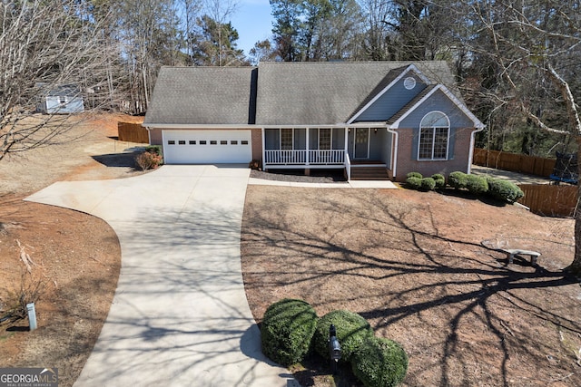 ranch-style home with fence, covered porch, concrete driveway, an attached garage, and brick siding