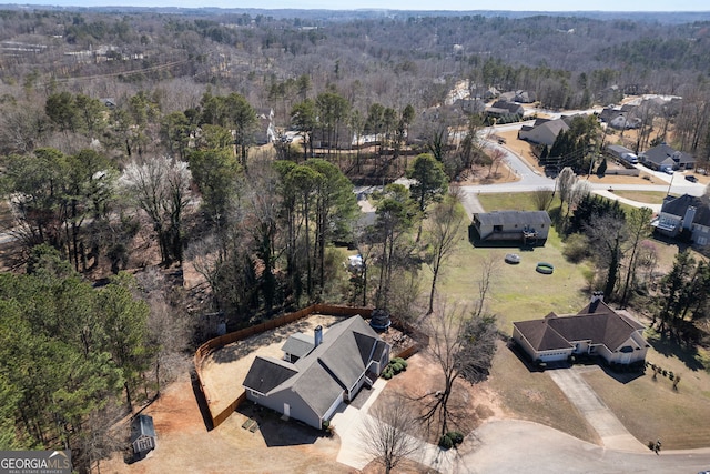 drone / aerial view featuring a forest view