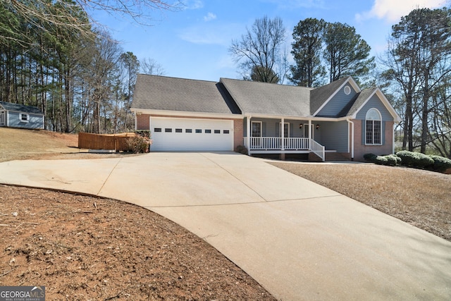 single story home with a garage, brick siding, covered porch, and driveway