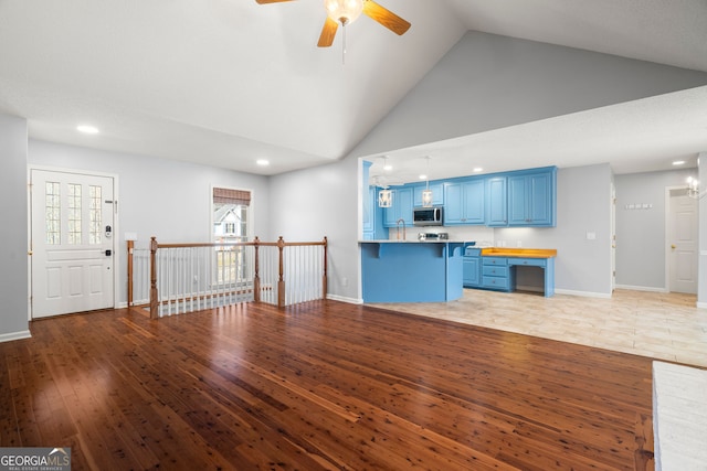 unfurnished living room with baseboards, high vaulted ceiling, ceiling fan, and light wood finished floors