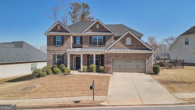 craftsman-style home with brick siding, driveway, a standing seam roof, and a garage