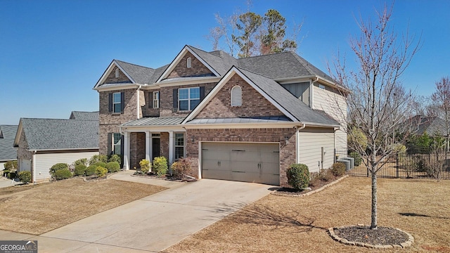 craftsman-style home with brick siding, a shingled roof, fence, driveway, and a standing seam roof