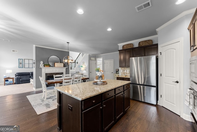 kitchen featuring tasteful backsplash, visible vents, appliances with stainless steel finishes, and dark wood-type flooring