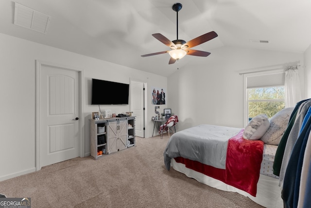 carpeted bedroom featuring visible vents, ceiling fan, and vaulted ceiling