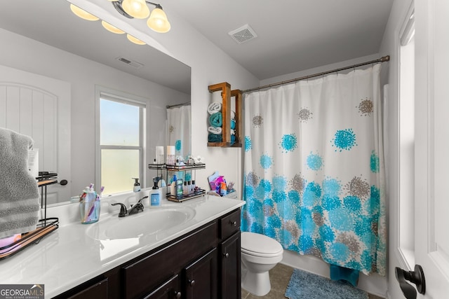 bathroom with vanity, visible vents, tile patterned flooring, shower / bath combination with curtain, and toilet