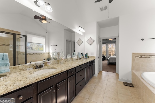 ensuite bathroom featuring a sink, visible vents, a ceiling fan, and tile patterned flooring