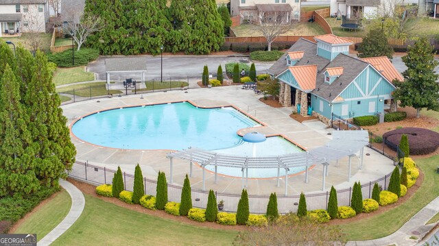 pool with a patio, a lawn, a pergola, and fence