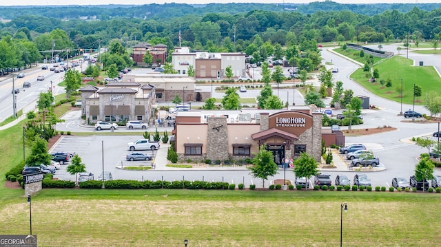 birds eye view of property featuring a view of trees