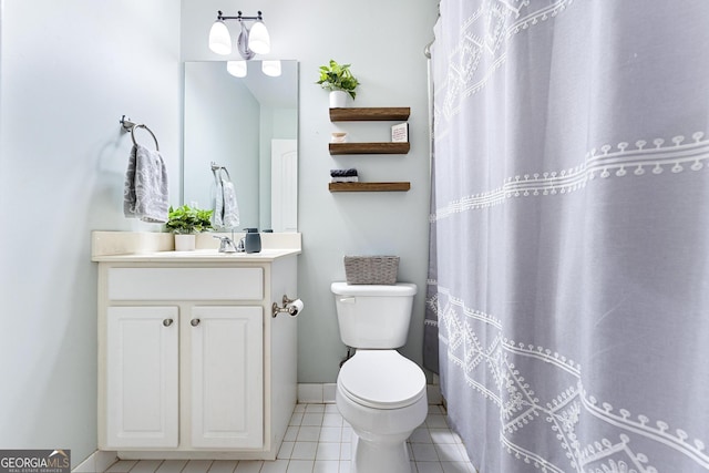 bathroom featuring baseboards, toilet, a shower with shower curtain, tile patterned floors, and vanity