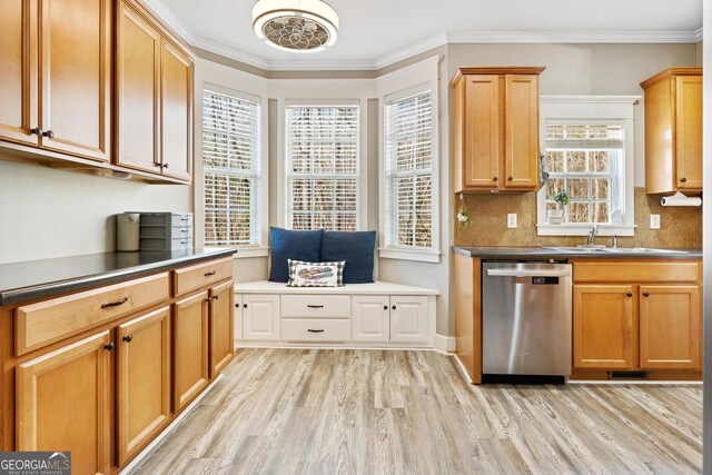 kitchen with dishwasher, light wood-style flooring, ornamental molding, and a sink