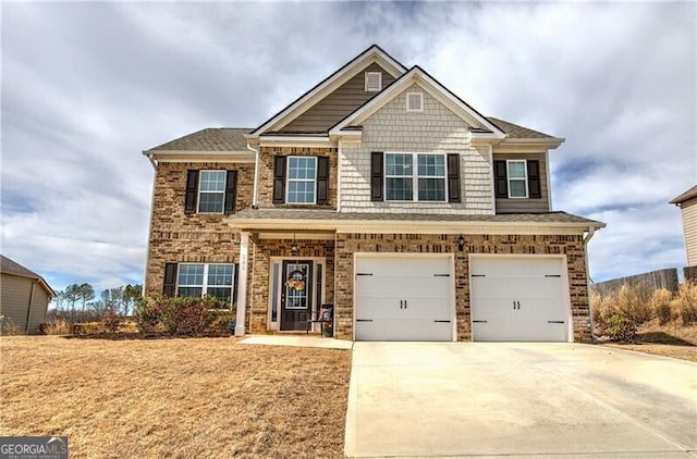 craftsman-style house featuring a garage, brick siding, and concrete driveway