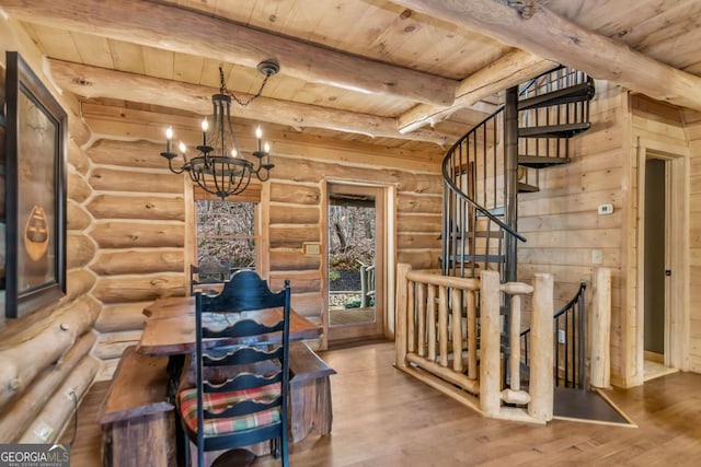 interior space featuring a chandelier, wood finished floors, beam ceiling, and wooden ceiling