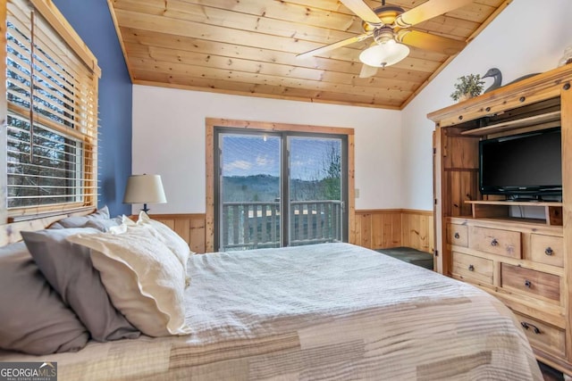 bedroom featuring access to exterior, wood ceiling, a wainscoted wall, and lofted ceiling