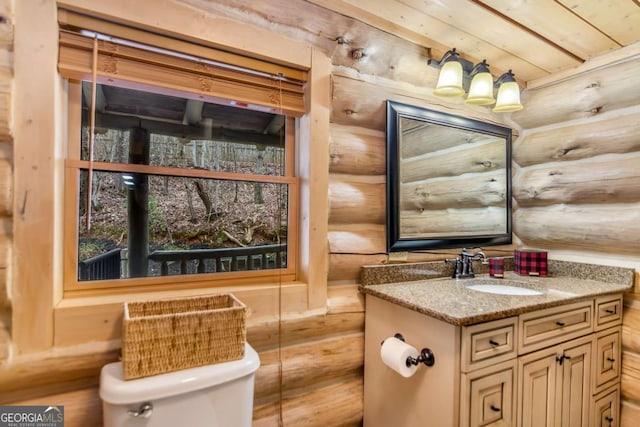 half bathroom featuring toilet and vanity