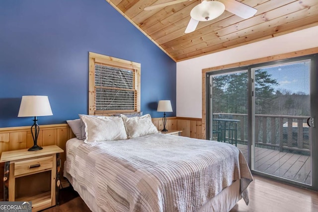 bedroom featuring access to outside, wood finished floors, wooden ceiling, wainscoting, and lofted ceiling