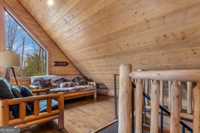 bedroom with wood walls, wooden ceiling, wood finished floors, and vaulted ceiling