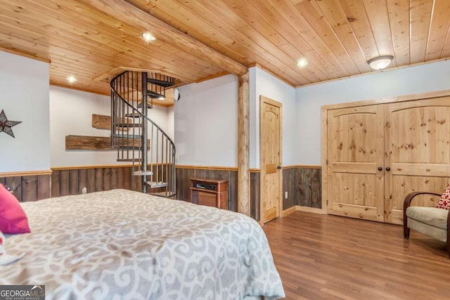 bedroom with wood walls, wood ceiling, recessed lighting, wainscoting, and wood finished floors