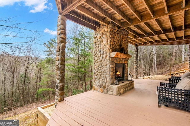 deck featuring an outdoor stone fireplace