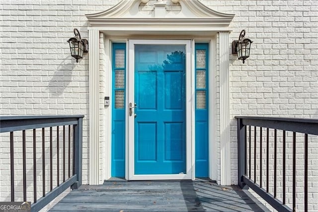 property entrance featuring brick siding