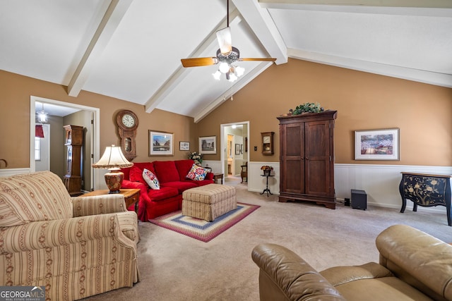 living area with lofted ceiling with beams, light colored carpet, and a ceiling fan