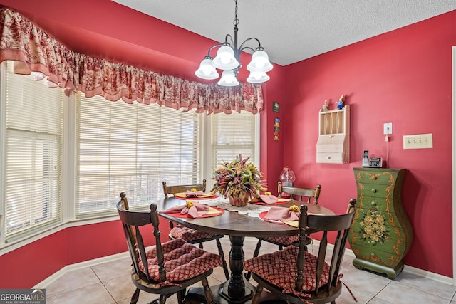 dining room featuring a notable chandelier, light tile patterned floors, baseboards, and a textured ceiling