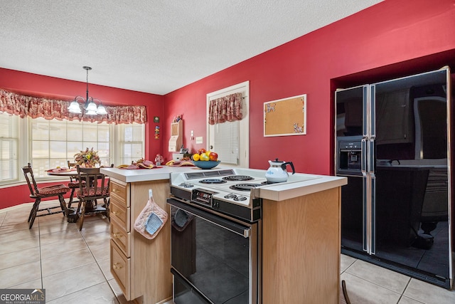 kitchen featuring a chandelier, light countertops, light tile patterned floors, electric stove, and a textured ceiling