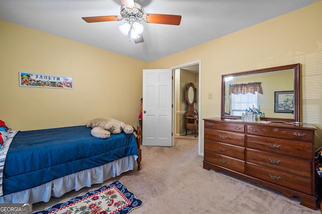 bedroom with light colored carpet and a ceiling fan