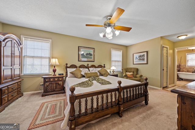 bedroom featuring multiple windows, light carpet, and baseboards