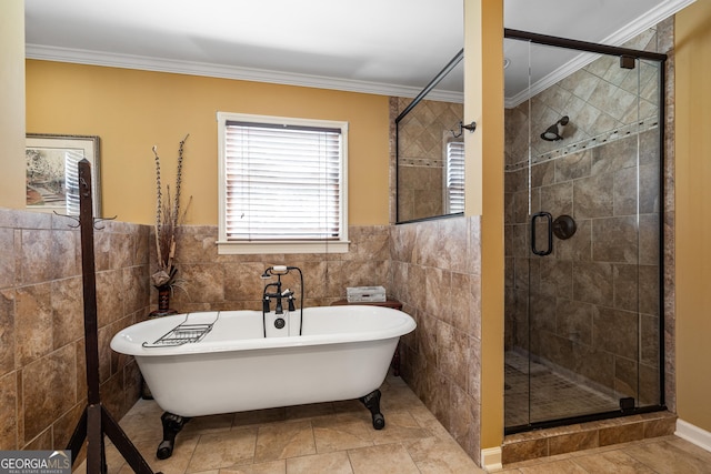 bathroom featuring a shower stall, a freestanding tub, tile walls, and ornamental molding