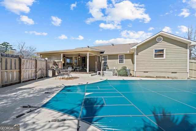 view of pool featuring a fenced backyard, a fenced in pool, a ceiling fan, and a patio