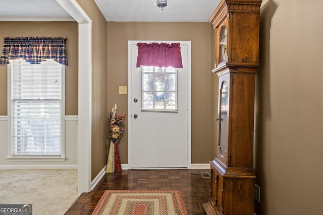 foyer featuring baseboards