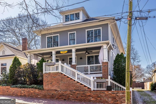 traditional style home with stairs, a porch, and a ceiling fan