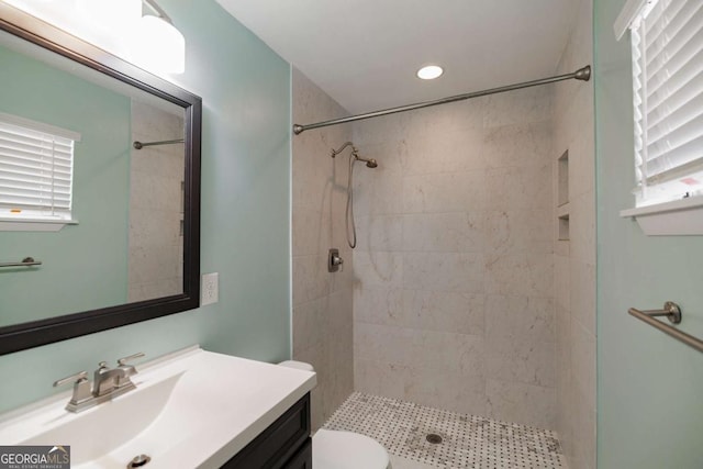 full bath featuring vanity, a shower stall, and toilet