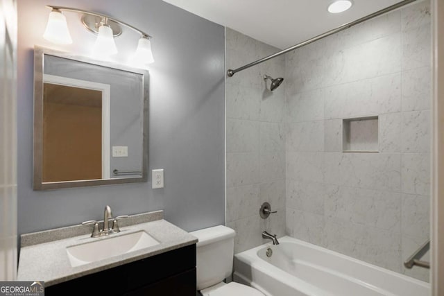 bathroom with toilet, vanity, and bathing tub / shower combination