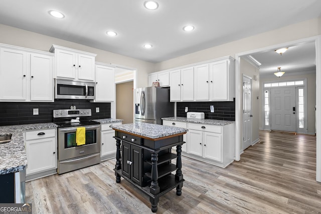 kitchen featuring appliances with stainless steel finishes, white cabinetry, and light wood-type flooring