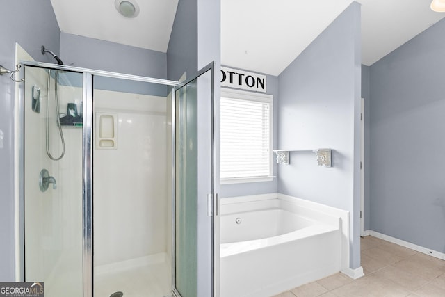 full bathroom featuring tile patterned floors, a shower stall, a bath, and baseboards