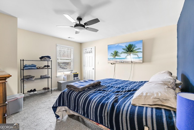 carpeted bedroom featuring visible vents, baseboards, and ceiling fan