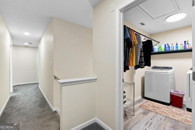 clothes washing area with washer and dryer, baseboards, attic access, and laundry area