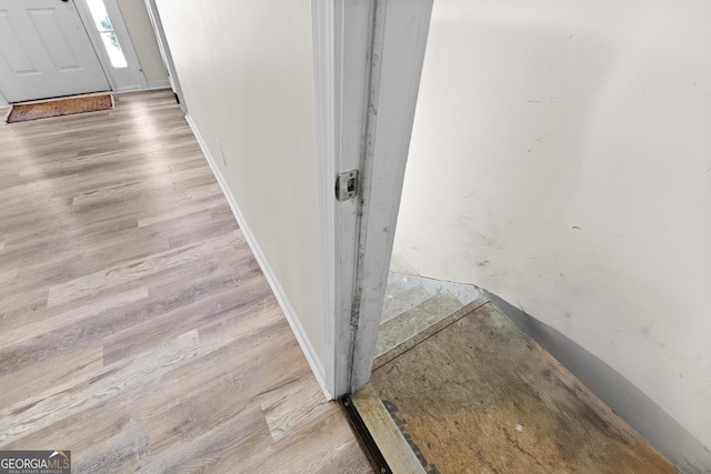 interior details featuring wood finished floors and baseboards