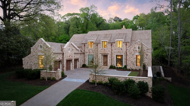 41 Blackland Rd NW, Atlanta, GA 30342 - french country inspired facade featuring a chimney, driveway, and a garage