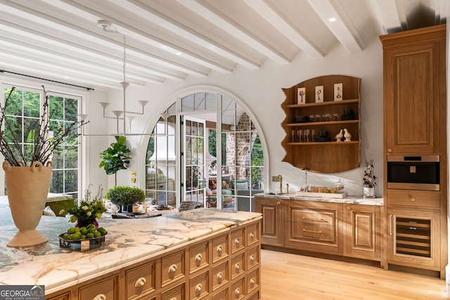 41 Blackland Rd NW, Atlanta, GA 30342 - bar with beverage cooler, light wood-style floors, stainless steel oven, arched walkways, and beamed ceiling