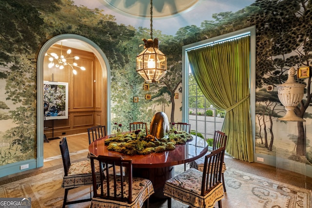 41 Blackland Rd NW, Atlanta, GA 30342 - dining room featuring wallpapered walls, arched walkways, an inviting chandelier, and light wood-style floors